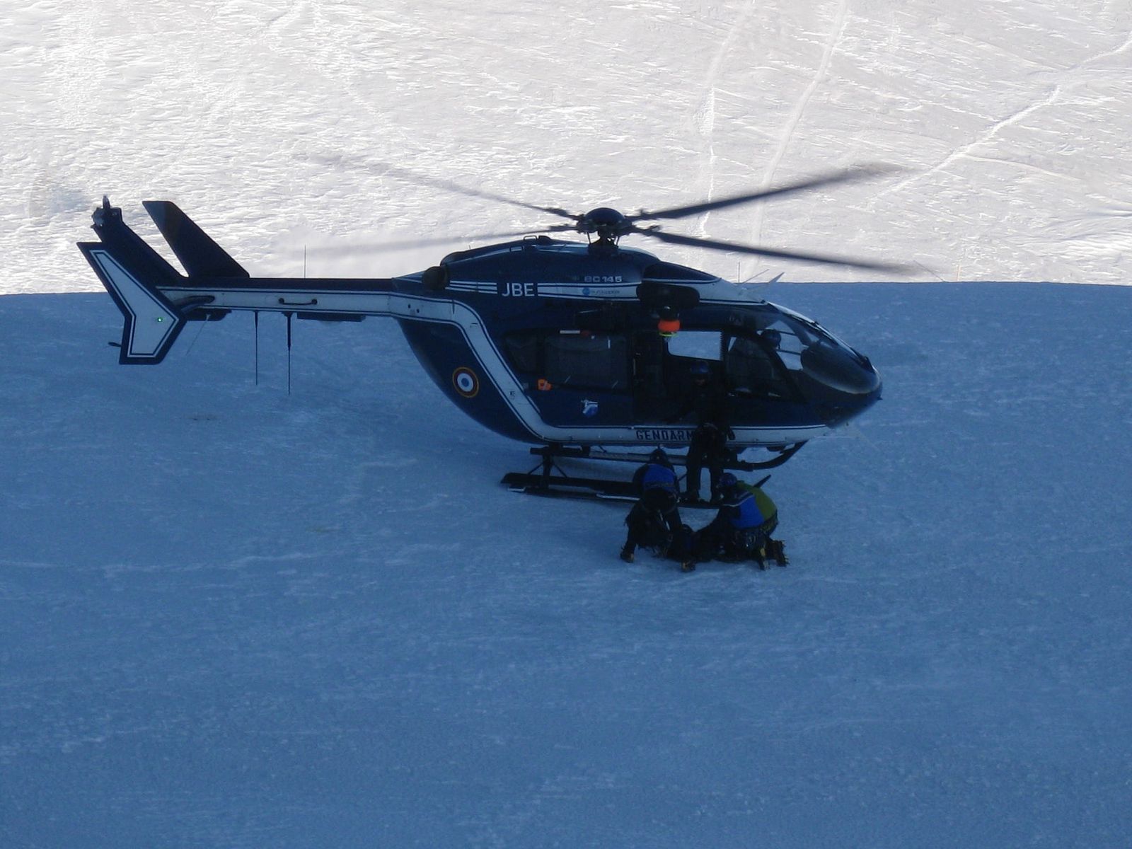 Gendarnerie loading Chris onto the chopper