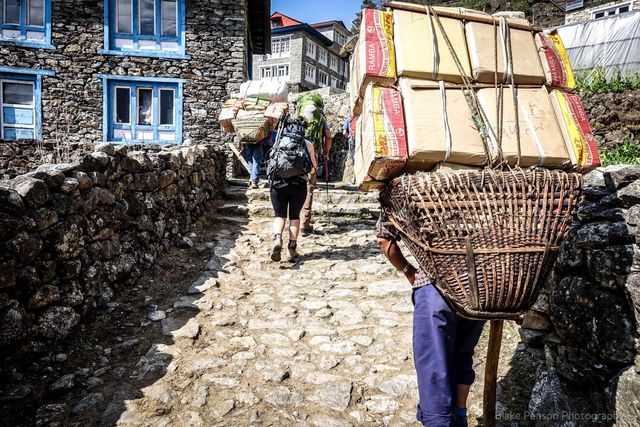 Porters carry huge loads out to supply the villages