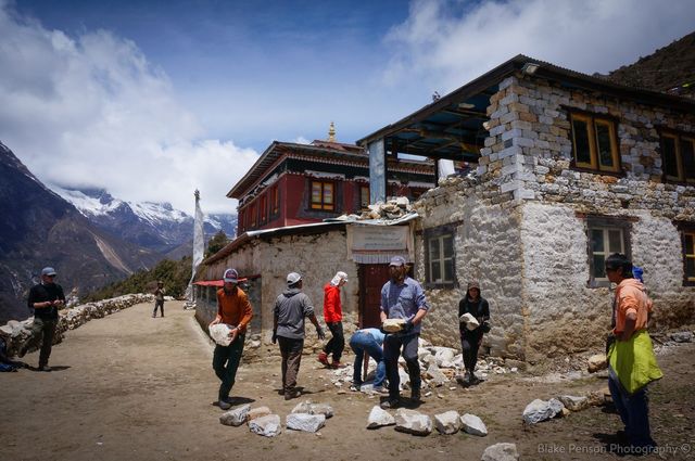 Clearing rubble from a damaged monastary which overlooks Phortse
