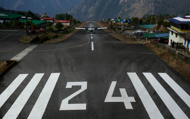 View from the end of the runway, a plane taking off
